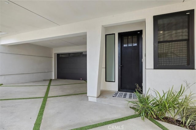 2004 Grant Ave Unit B, Redondo Beach, CA 90278 - view of exterior entry with a garage, stucco siding, and driveway