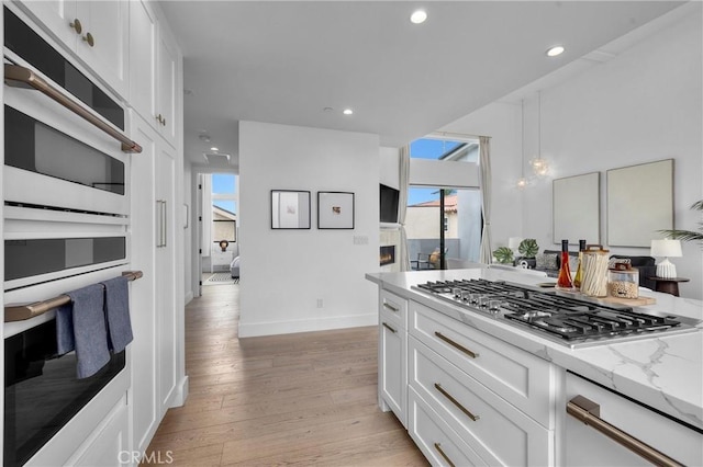 2004 Grant Ave Unit B, Redondo Beach, CA 90278 - kitchen with stainless steel gas cooktop, light wood-style flooring, white cabinetry, light stone counters, and recessed lighting