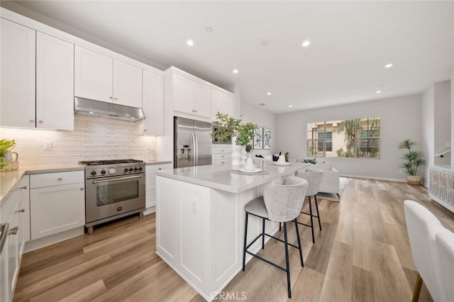 206 Milky Way, Irvine, CA 92618 - kitchen featuring appliances with stainless steel finishes, under cabinet range hood, open floor plan, white cabinets, and recessed lighting