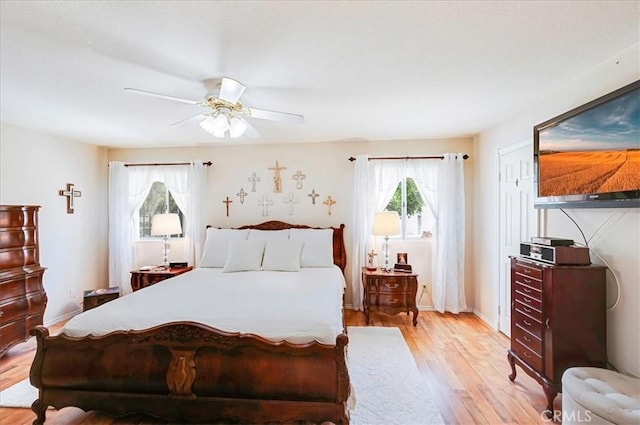 21332 Silver Spur Ln, Wildomar, CA 92595 - bedroom with multiple windows, light wood finished floors, and a ceiling fan