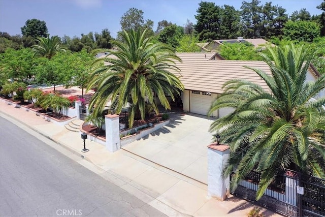 21332 Silver Spur Ln, Wildomar, CA 92595 - obstructed view of property with a garage, concrete driveway, and view of scattered trees