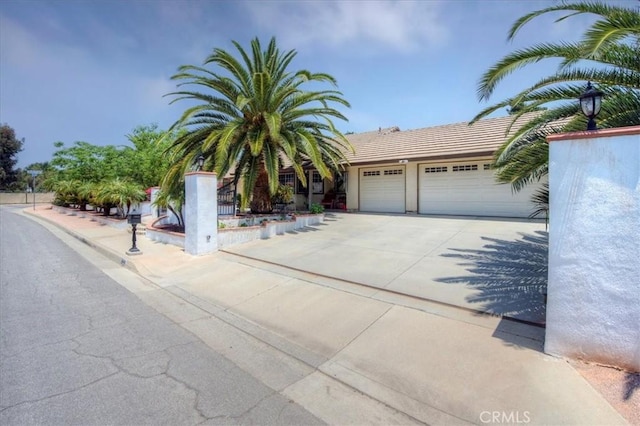 21332 Silver Spur Ln, Wildomar, CA 92595 - view of property hidden behind natural elements featuring concrete driveway and a garage