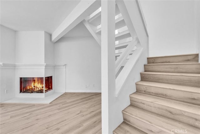 13104 Glen Ct Unit 28, Chino Hills, CA 91709 - stairway featuring wood finished floors and a multi sided fireplace