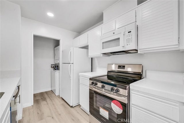 13104 Glen Ct Unit 28, Chino Hills, CA 91709 - kitchen with white appliances, stacked washing machine and dryer, white cabinetry, light wood-style flooring, and light countertops
