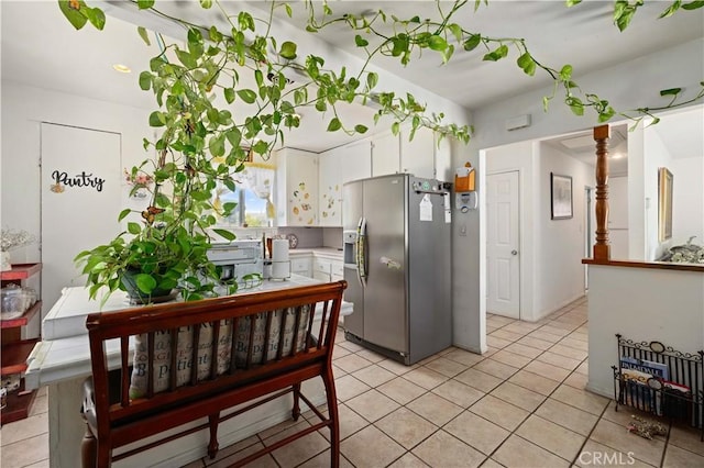 38614 Puerta Ave, Palmdale, CA 93550 - kitchen featuring stainless steel fridge with ice dispenser, white cabinets, and light tile patterned flooring