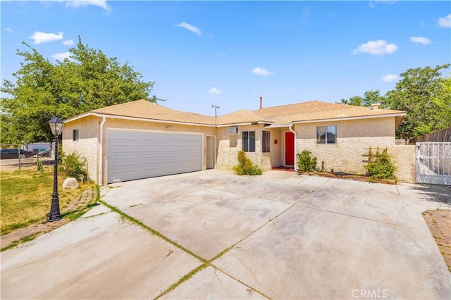 38614 Puerta Ave, Palmdale, CA 93550 - ranch-style house featuring stucco siding, driveway, an attached garage, and a gate