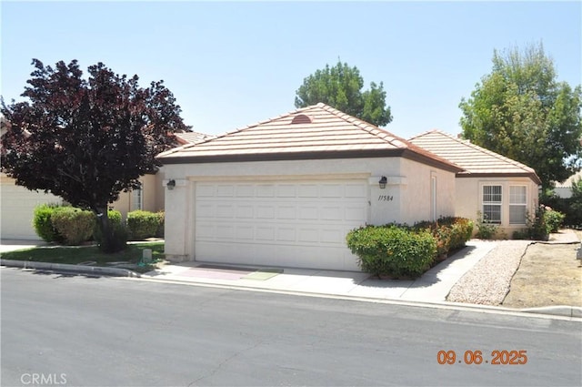 11584 Oak St, Apple Valley, CA 92308 - ranch-style house featuring a garage, stucco siding, and a tiled roof