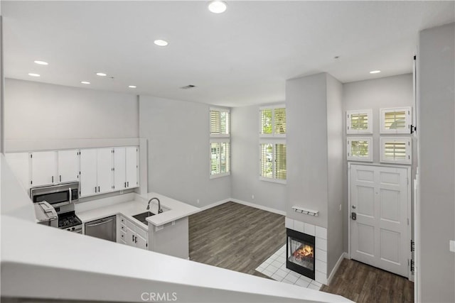 8308 Atlanta Ave Unit 101, Huntington Beach, CA 92646 - kitchen featuring appliances with stainless steel finishes, a sink, dark wood-style floors, light countertops, and recessed lighting