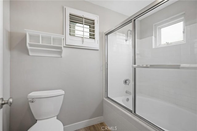 8308 Atlanta Ave Unit 101, Huntington Beach, CA 92646 - full bathroom with enclosed tub / shower combo, toilet, wood finished floors, and baseboards