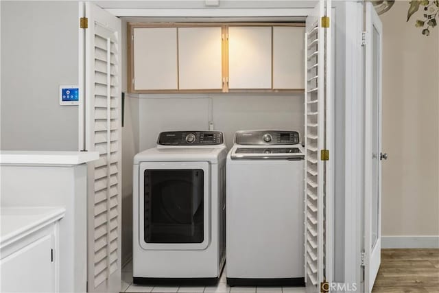 8308 Atlanta Ave Unit 101, Huntington Beach, CA 92646 - washroom featuring cabinet space and washer and dryer
