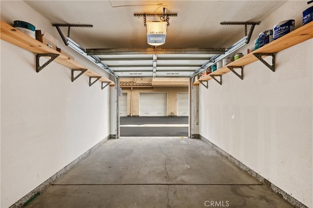 8308 Atlanta Ave Unit 101, Huntington Beach, CA 92646 - garage featuring baseboards and a garage door opener