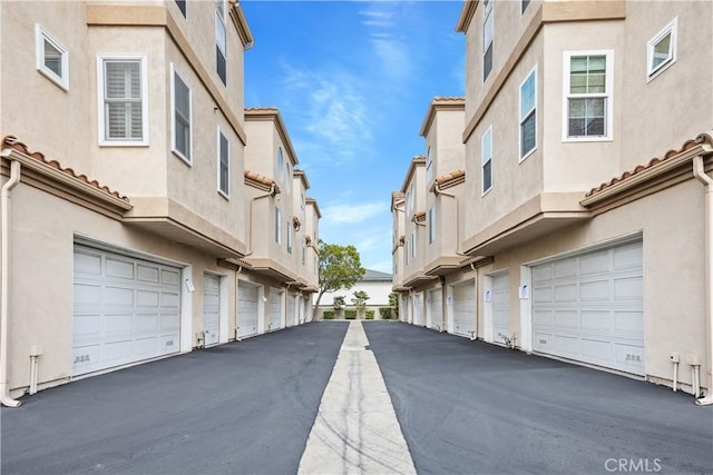 8308 Atlanta Ave Unit 101, Huntington Beach, CA 92646 - view of asphalt road featuring community garages