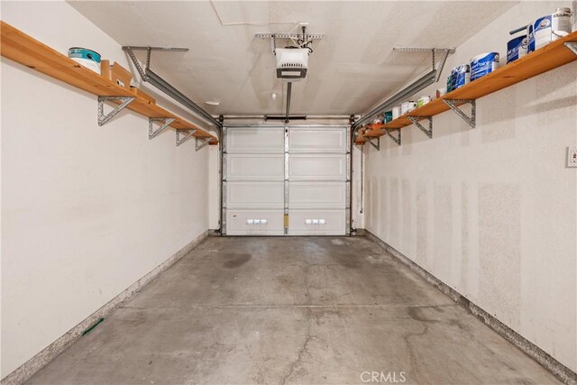 8308 Atlanta Ave Unit 101, Huntington Beach, CA 92646 - garage with a garage door opener and baseboards