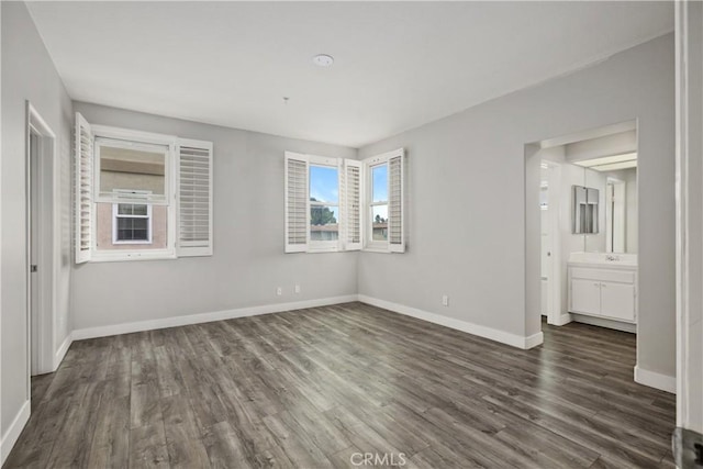 8308 Atlanta Ave Unit 101, Huntington Beach, CA 92646 - unfurnished bedroom featuring dark wood-style flooring and baseboards