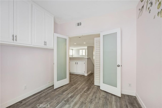 8308 Atlanta Ave Unit 101, Huntington Beach, CA 92646 - unfurnished dining area featuring wood finished floors and baseboards