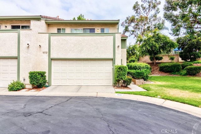 1666 Albany Ct, Claremont, CA 91711 - view of front facade with stucco siding, a garage, and concrete driveway