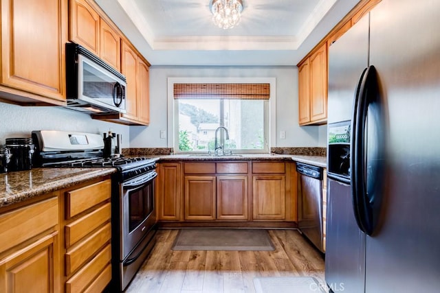 1666 Albany Ct, Claremont, CA 91711 - kitchen with stainless steel appliances, light wood-type flooring, a tray ceiling, ornamental molding, and a chandelier