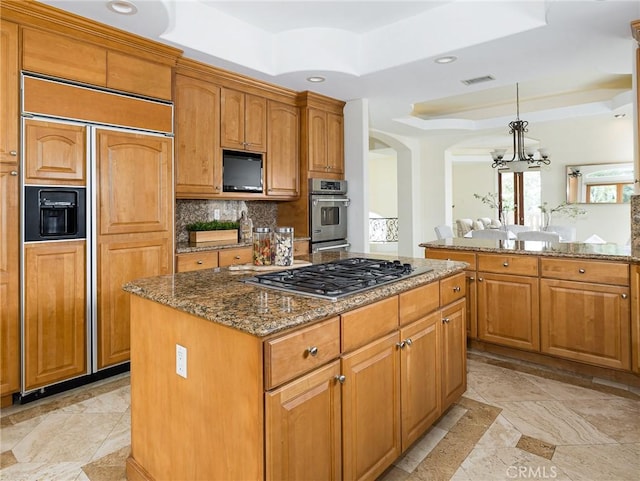 120 Via Alameda, Redondo Beach, CA 90277 - kitchen featuring appliances with stainless steel finishes, a chandelier, a raised ceiling, arched walkways, and stone countertops