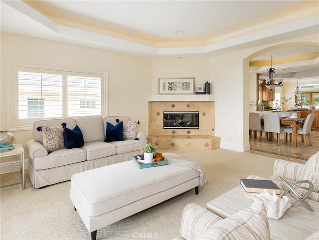 120 Via Alameda, Redondo Beach, CA 90277 - carpeted living area featuring a raised ceiling, a chandelier, arched walkways, and a premium fireplace