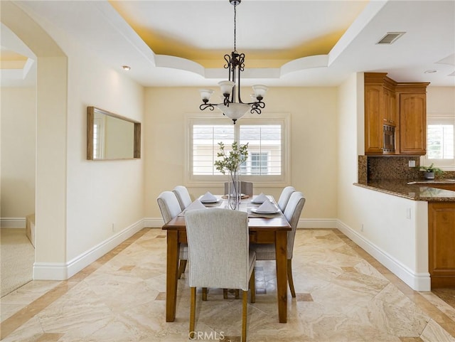 120 Via Alameda, Redondo Beach, CA 90277 - dining room featuring a raised ceiling, a chandelier, baseboards, and inlaid floor details