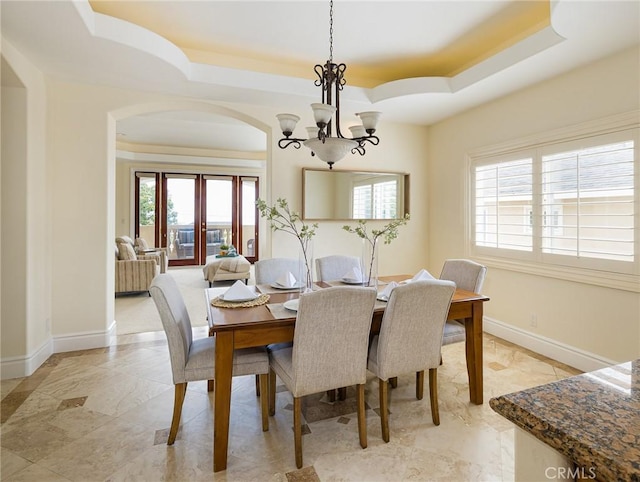 120 Via Alameda, Redondo Beach, CA 90277 - dining space featuring a tray ceiling, healthy amount of natural light, a chandelier, and arched walkways