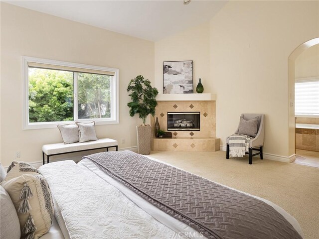 120 Via Alameda, Redondo Beach, CA 90277 - bedroom featuring arched walkways, lofted ceiling, a tile fireplace, carpet flooring, and ensuite bath