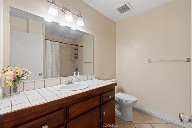 1257 N Brookhurst St, Anaheim, CA 92801 - full bath with toilet, tile patterned floors, vanity, curtained shower, and baseboards