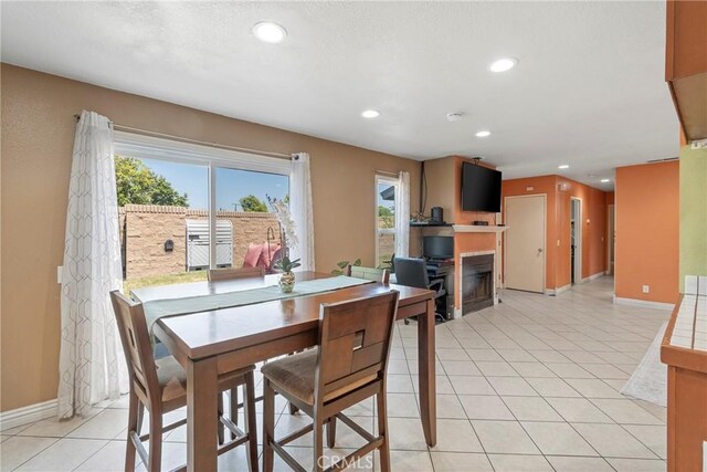 1257 N Brookhurst St, Anaheim, CA 92801 - dining room with a glass covered fireplace, recessed lighting, baseboards, and light tile patterned flooring