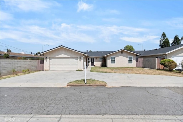 1257 N Brookhurst St, Anaheim, CA 92801 - ranch-style house featuring driveway, a garage, and stucco siding