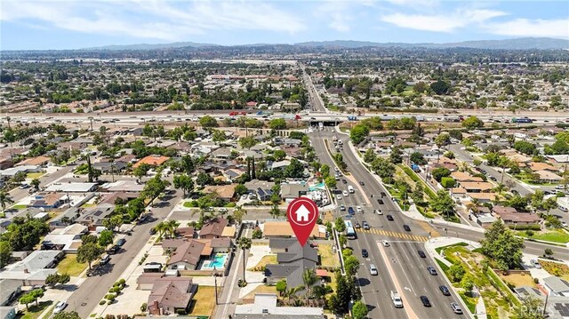 1257 N Brookhurst St, Anaheim, CA 92801 - aerial view of property and surrounding area with mountains, a main thoroughfare, and nearby suburban area