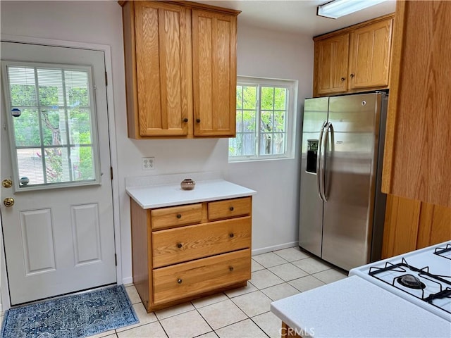 959 Post Rd, Costa Mesa, CA 92626 - kitchen with stainless steel refrigerator with ice dispenser, healthy amount of natural light, light tile patterned floors, and light countertops