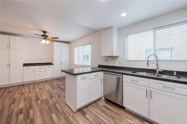 2254 Gaviota Ave Unit 11, Signal Hill, CA 90755 - kitchen featuring stainless steel dishwasher, a sink, a peninsula, light wood-style flooring, and white cabinetry