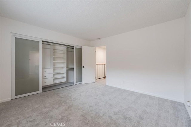 2254 Gaviota Ave Unit 11, Signal Hill, CA 90755 - unfurnished bedroom with light carpet, baseboards, and a closet