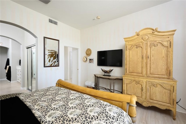 11 Classico Dr, Newport Coast, CA 92657 - bedroom featuring arched walkways and light wood-style flooring
