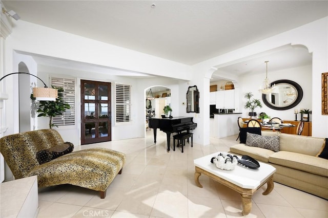 11 Classico Dr, Newport Coast, CA 92657 - living room featuring arched walkways, light tile patterned floors, and a chandelier