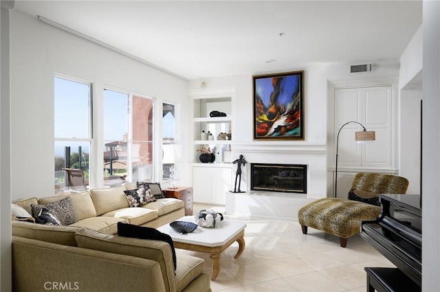 11 Classico Dr, Newport Coast, CA 92657 - living room featuring built in shelves, a glass covered fireplace, and light tile patterned flooring