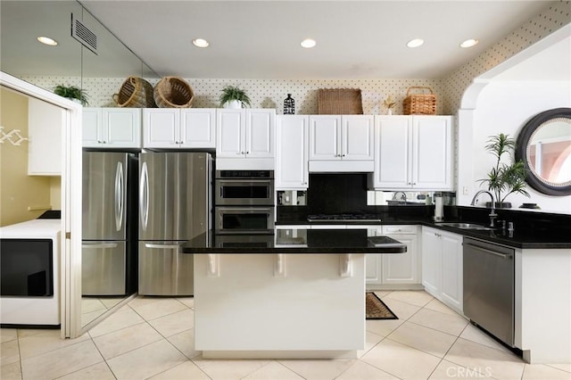 11 Classico Dr, Newport Coast, CA 92657 - kitchen featuring appliances with stainless steel finishes, a kitchen island, under cabinet range hood, white cabinetry, and recessed lighting