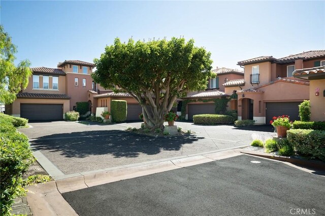 11 Classico Dr, Newport Coast, CA 92657 - mediterranean / spanish-style house featuring driveway, a garage, stucco siding, and a tile roof
