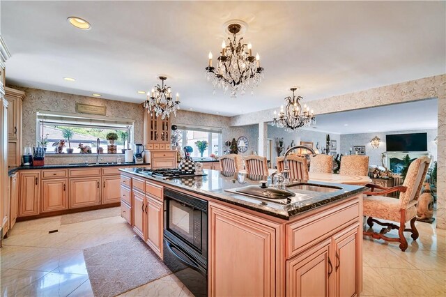 15850 Arbela Dr, Whittier, CA 90603 - kitchen featuring a chandelier, black microwave, a kitchen island with sink, a warming drawer, and light brown cabinetry