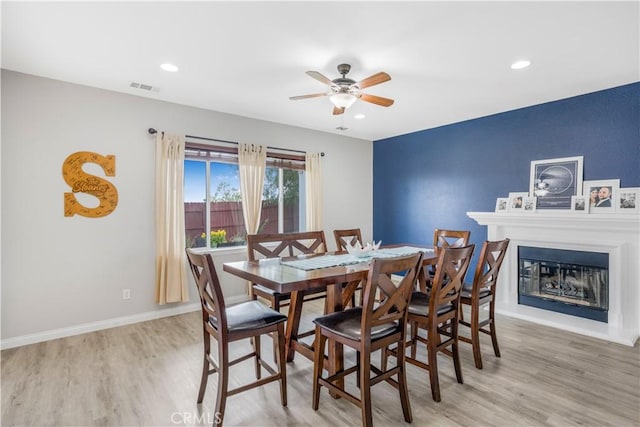 3822 Jupiter Ave, Lompoc, CA 93436 - dining area featuring a ceiling fan, light wood finished floors, recessed lighting, and a glass covered fireplace
