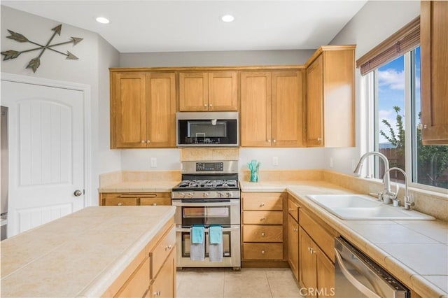 3822 Jupiter Ave, Lompoc, CA 93436 - kitchen featuring stainless steel appliances, tile countertops, plenty of natural light, recessed lighting, and light tile patterned flooring