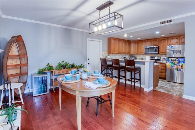 64 Seacrest Ct, Long Beach, CA 90803 - dining area featuring hardwood / wood-style flooring and crown molding