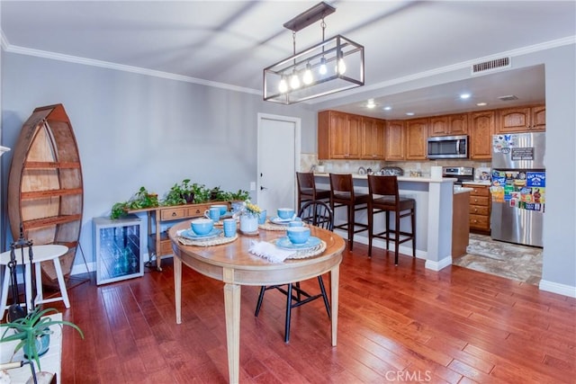 64 Seacrest Ct, Long Beach, CA 90803 - dining space featuring wood-type flooring, crown molding, and recessed lighting