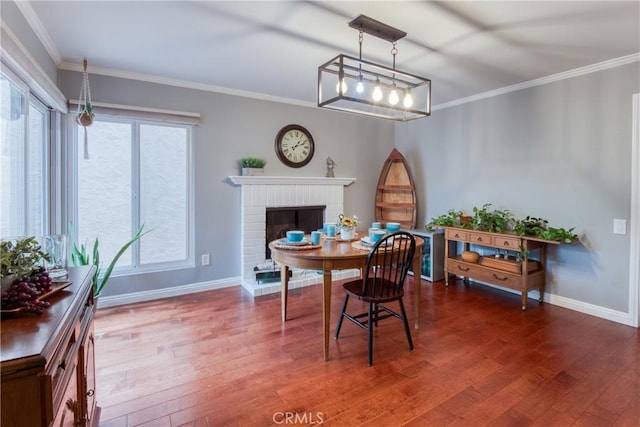 64 Seacrest Ct, Long Beach, CA 90803 - dining space featuring wood finished floors, plenty of natural light, crown molding, and a brick fireplace