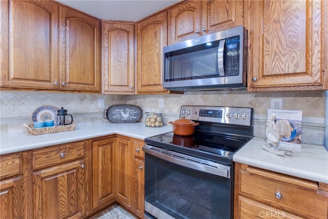 64 Seacrest Ct, Long Beach, CA 90803 - kitchen with appliances with stainless steel finishes, brown cabinetry, and light countertops