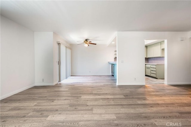 2051 Orizaba Ave Unit 8, Signal Hill, CA 90755 - unfurnished living room with a ceiling fan and light wood-style floors