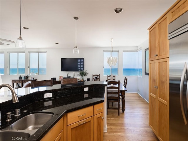 209 41st, Manhattan Beach, CA 90266 - kitchen featuring stainless steel built in refrigerator, decorative light fixtures, light wood-style floors, a chandelier, and dark stone countertops