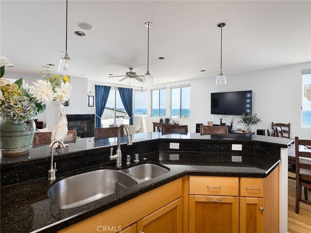 209 41st, Manhattan Beach, CA 90266 - kitchen with open floor plan, hanging light fixtures, and dark stone counters