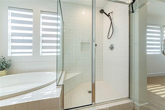 20754 W Bur Oak Cir, Porter Ranch, CA 91326 - bathroom featuring a shower stall, a garden tub, and wood finished floors