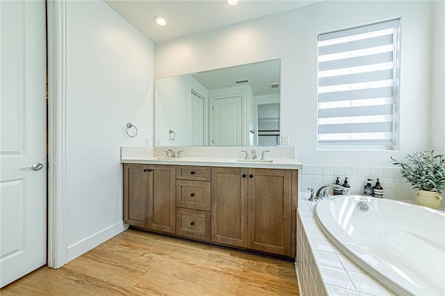 20754 W Bur Oak Cir, Porter Ranch, CA 91326 - bathroom with double vanity, a garden tub, and wood finished floors